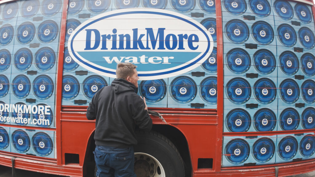 DrinkMore truck and employee making home delivery